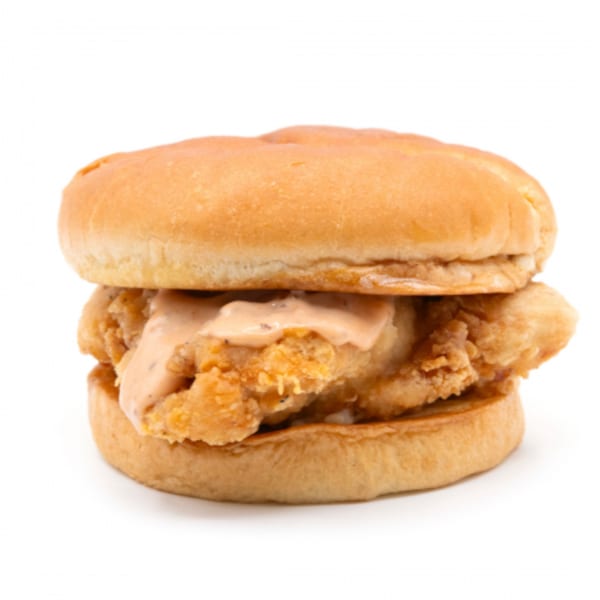 Connie's Chicken fried chicken sandwich with sauce on a bun, isolated on a white background.