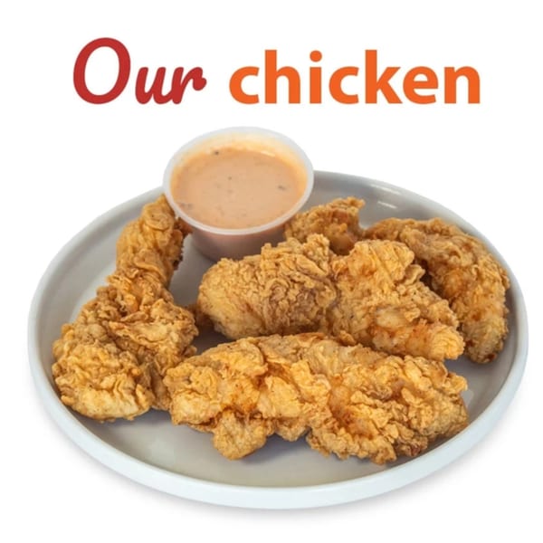 A plate of crispy fried chicken tenders with a side of dipping sauce.